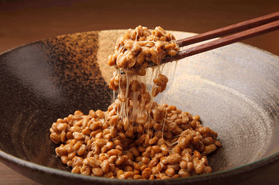 A bowl of soybeans that look like they have cheese on them, but it's not cheese.