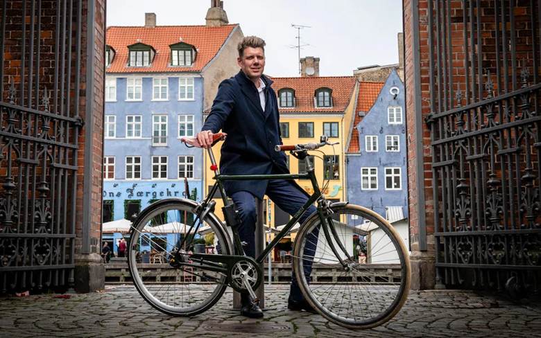 Morten Scheibye-Knudsen standing with his bicycle in Copenhagen, Denmark