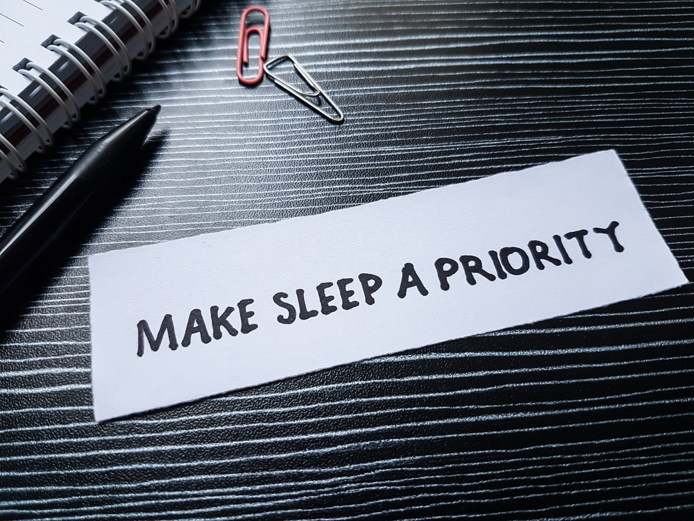 A sign that says, "Make sleep a priority."